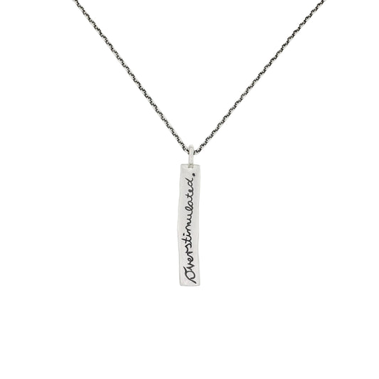 Eine Halskette aus 925 Sterling Silber mit dem länglichen rechteckigen gravierten Anhänger. Gravur mit Handschrift 'Overstimulated'. Handgemachter Mental Health Schmuck.