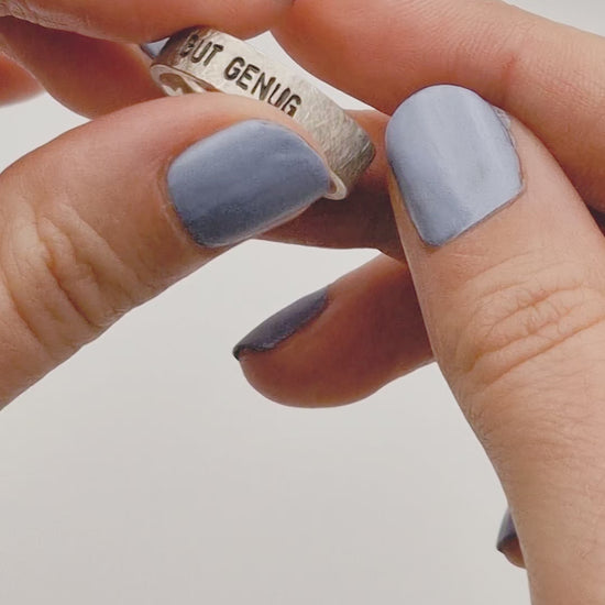 Handgeschmiedeter feministischer Statement-Ring  mit Wunschgravur „GUT GENUG“ aus 925 Sterling Silber. Der Ring wird am Finger getragen und zeigt die Gravur sowie die bewusst grob gefeilte und gekratzte Oberfläche.